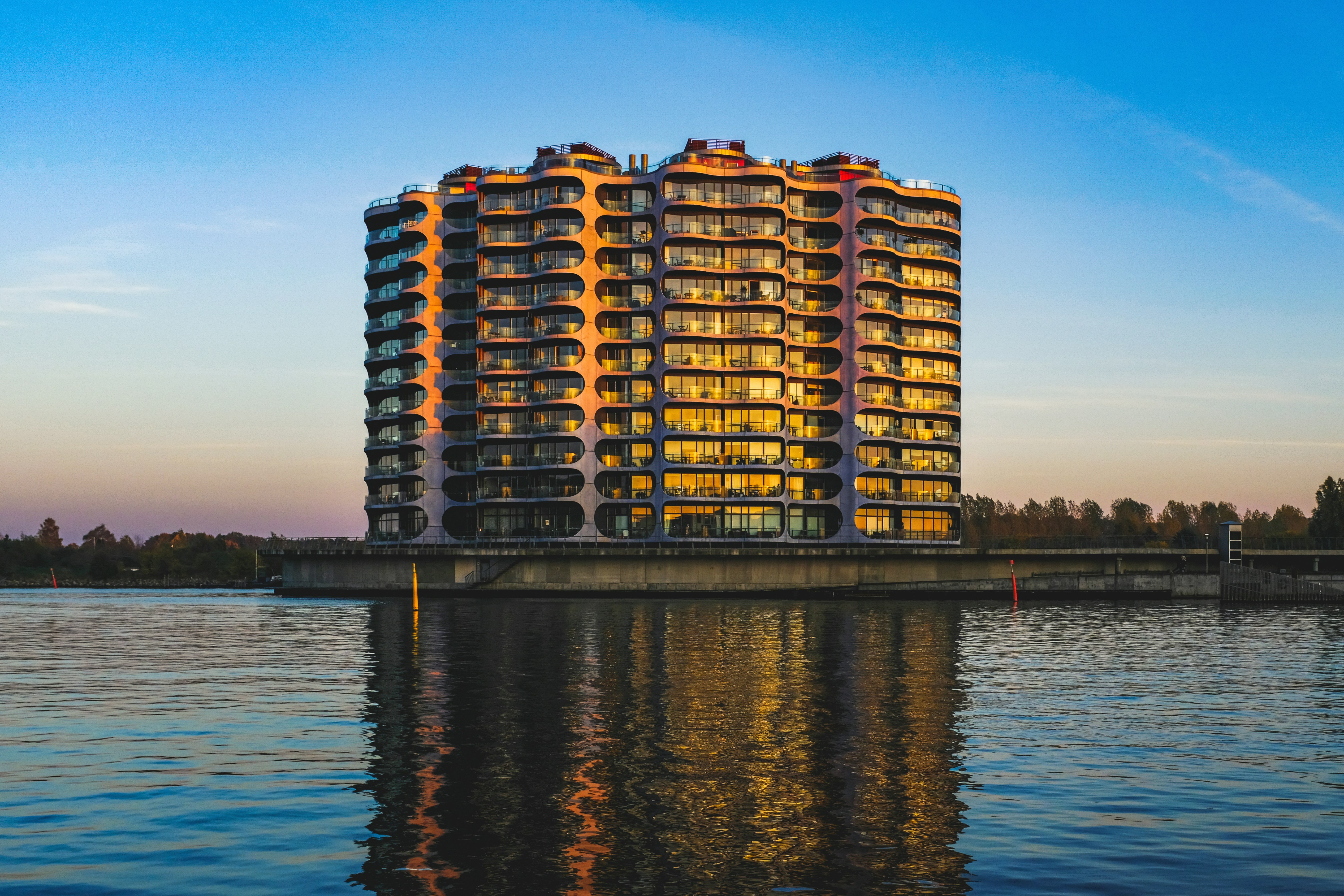 brown and white high rise building near body of water during daytime